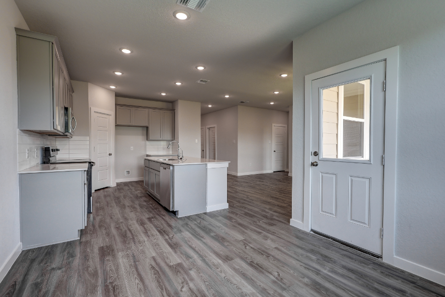 A large kitchen with white cabinets.