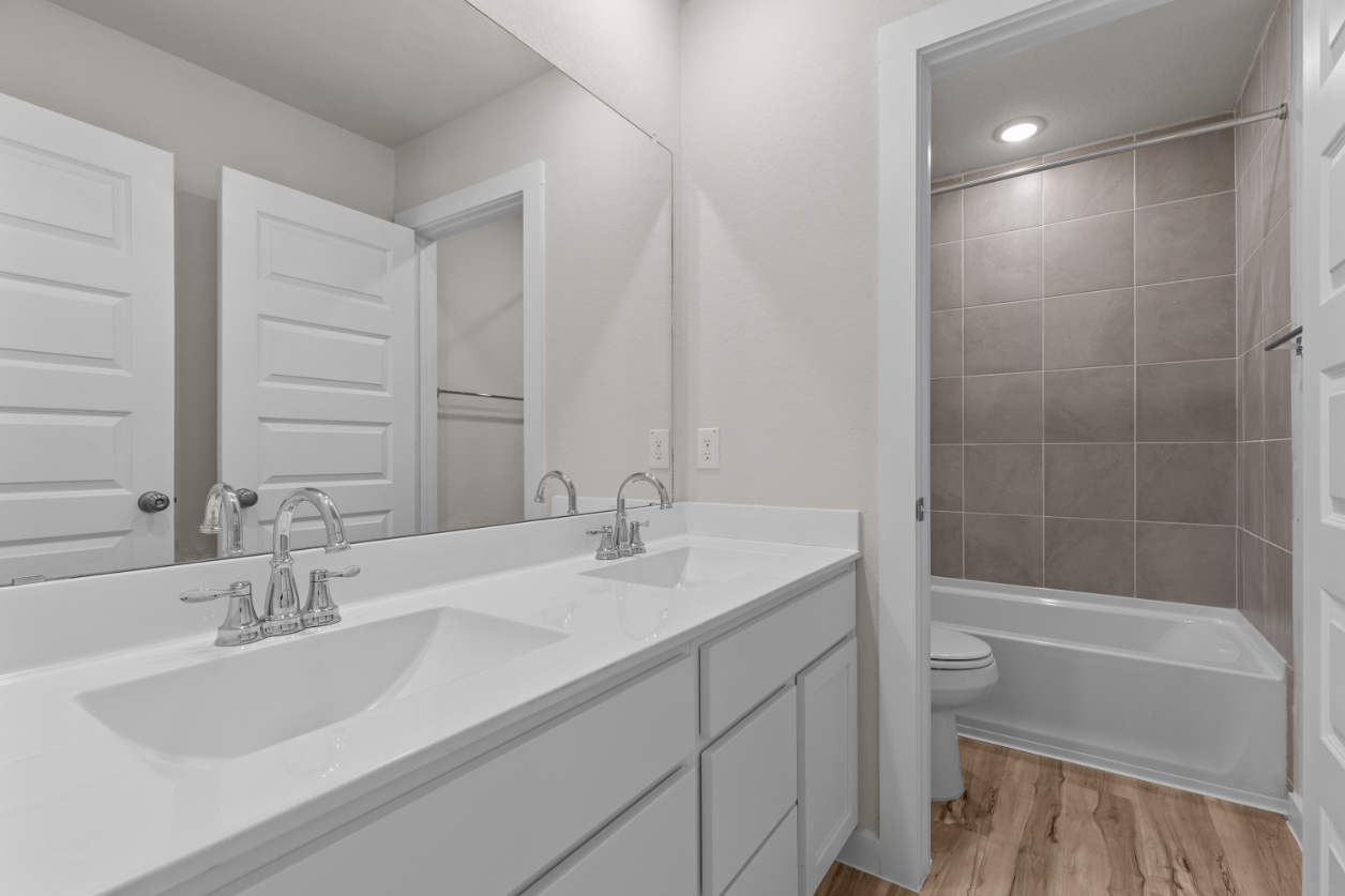 A bathroom with a tub sink and toilet.