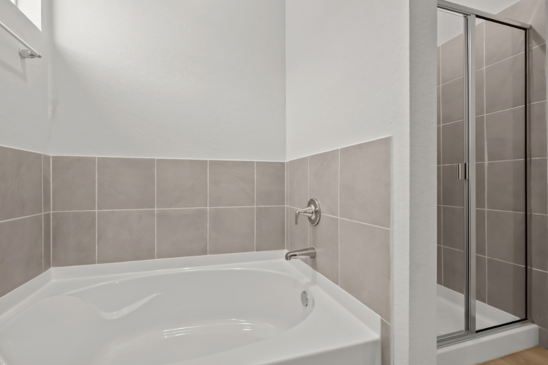 A bathtub in a bathroom.