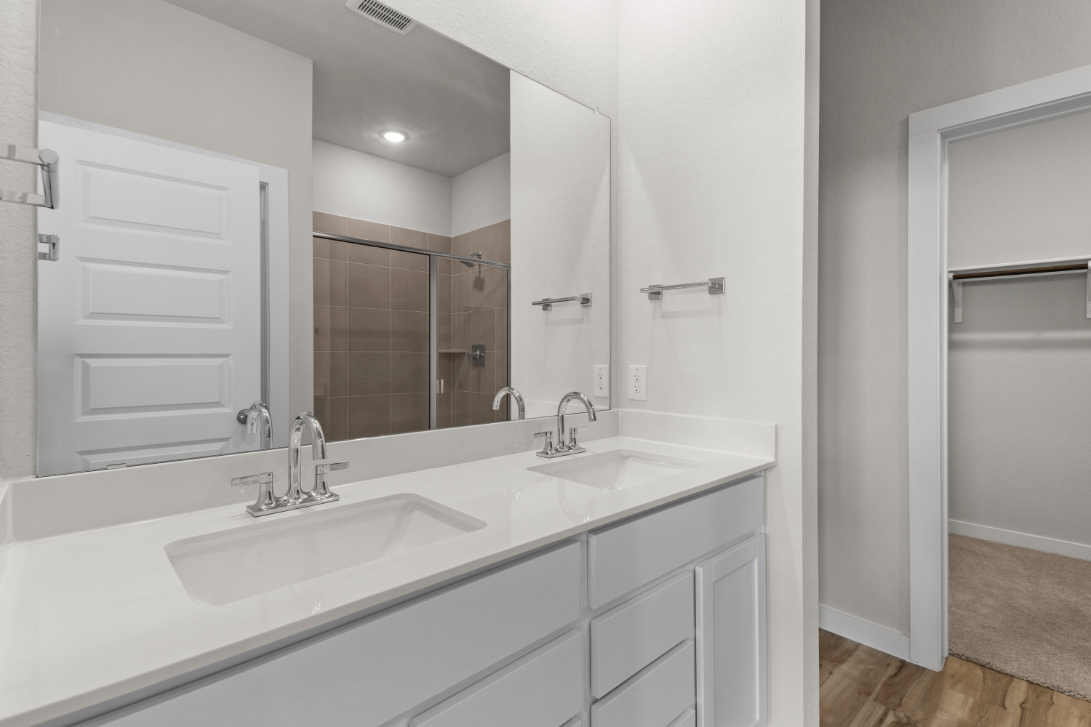 A bathroom with a large mirror.