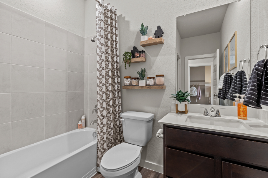 A bathroom with a tub toilet and sink.