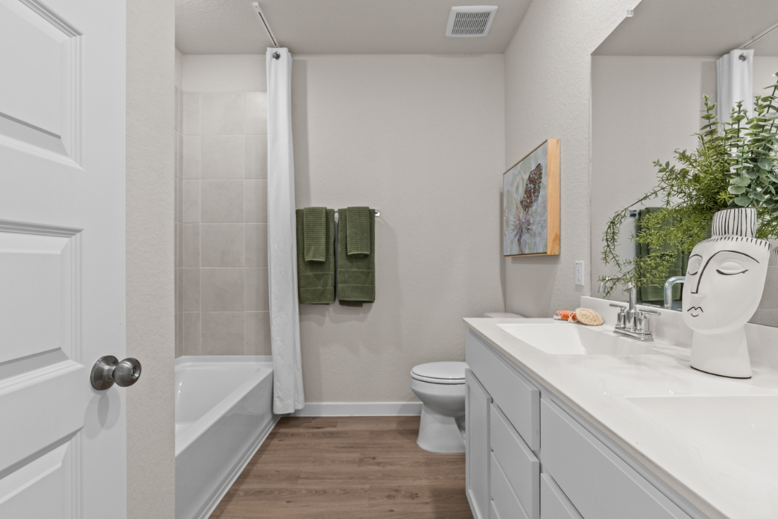 A bathroom with a tub toilet and sink.