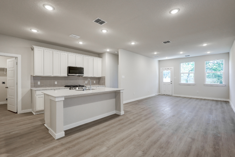 A kitchen with white cabinets.