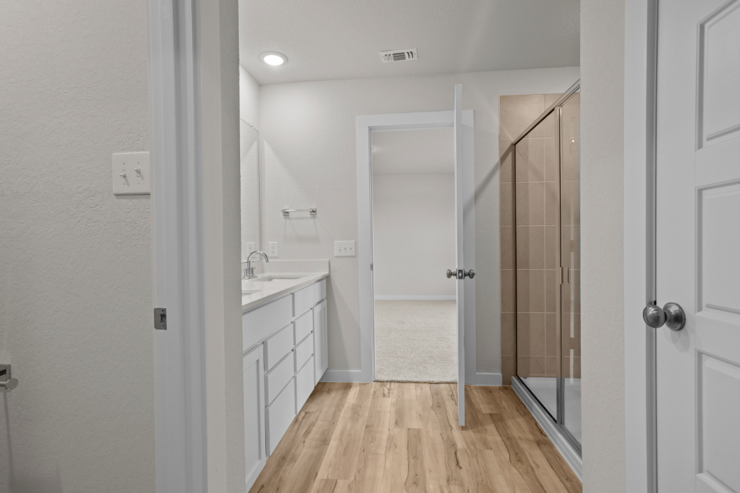 A bathroom with a shower and a sink.