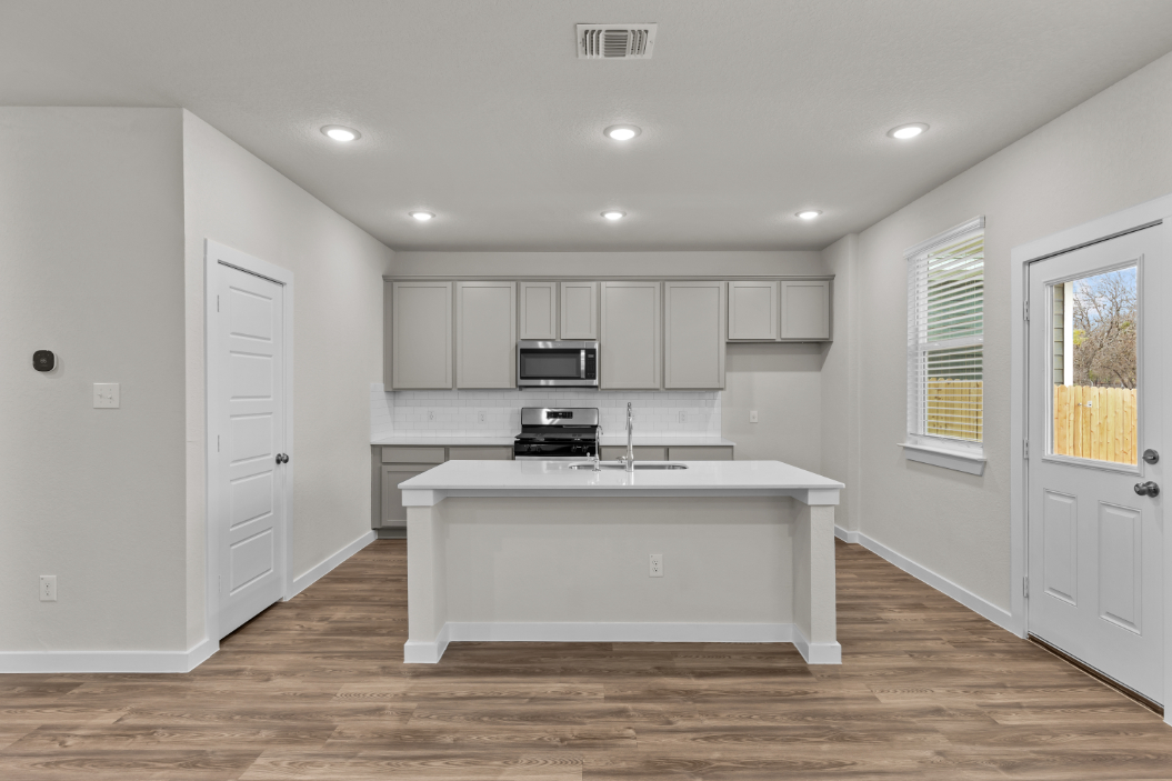 A kitchen with white cabinets.