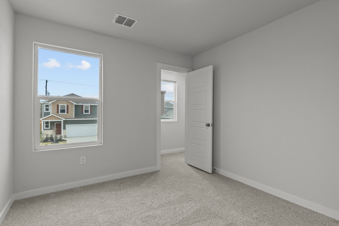 A room with white walls and a window.