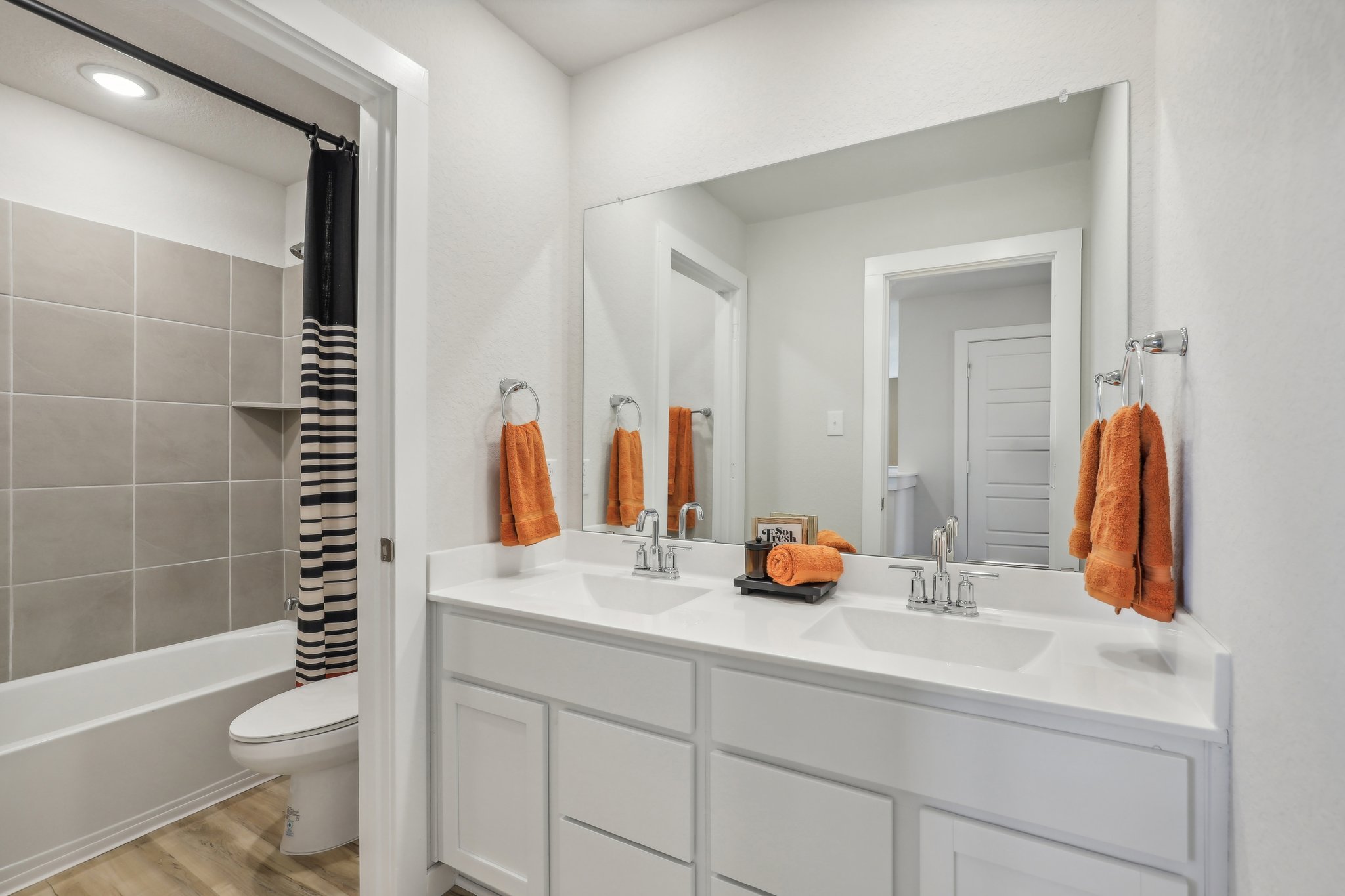 A bathroom with a sink toilet and bathtub.