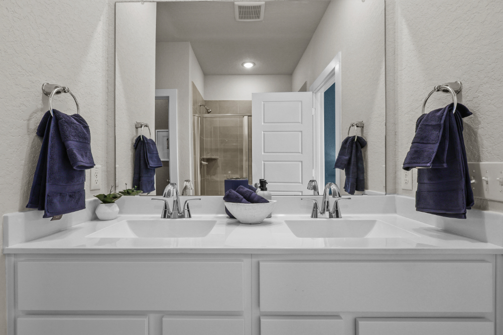 A bathroom with a sink and towels.