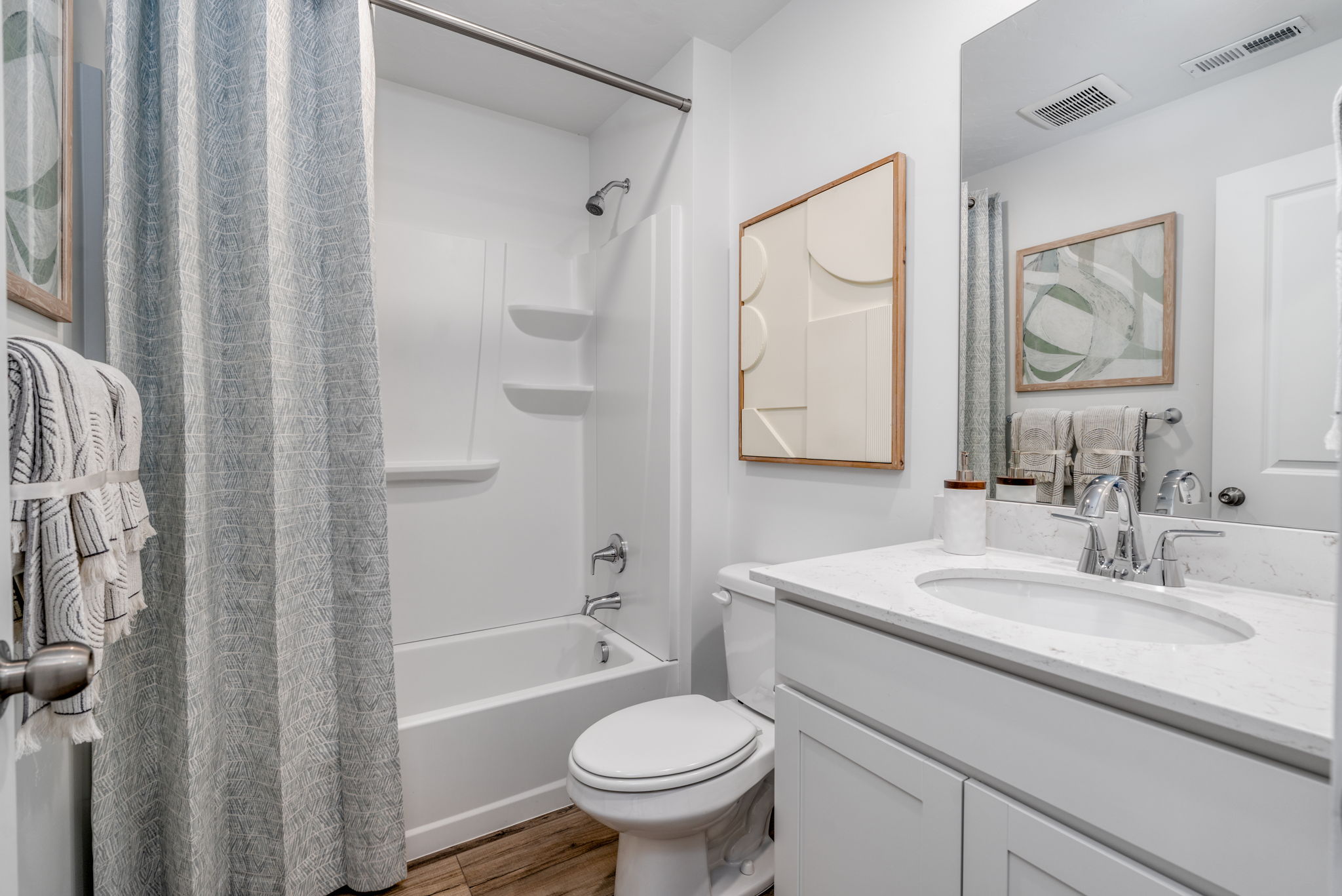 A bathroom with a tub sink and toilet.