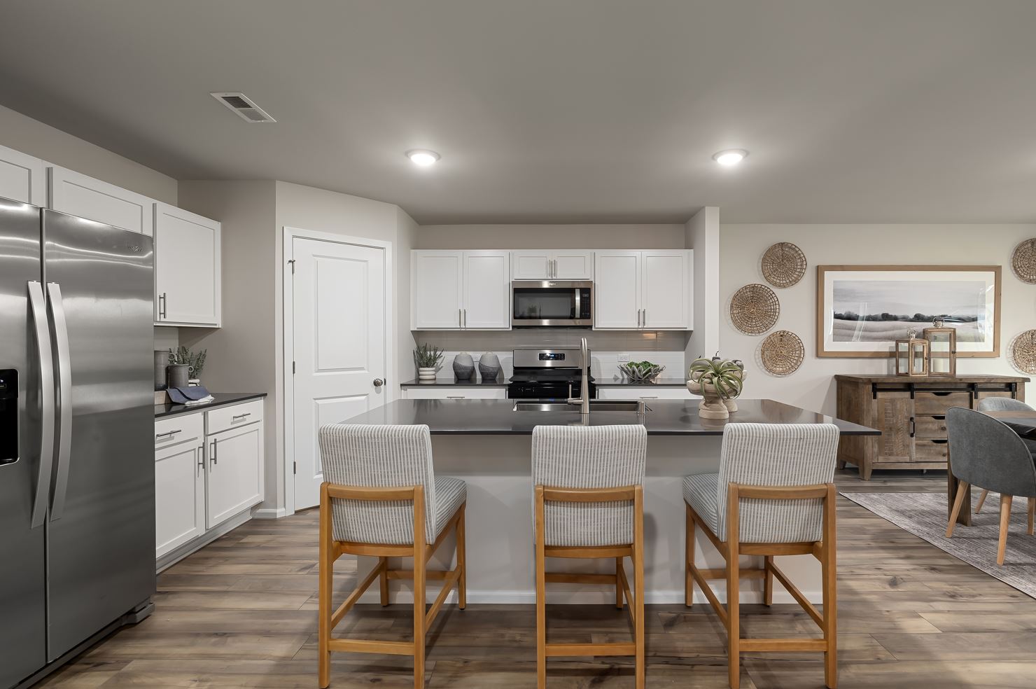 A kitchen with white cabinets.