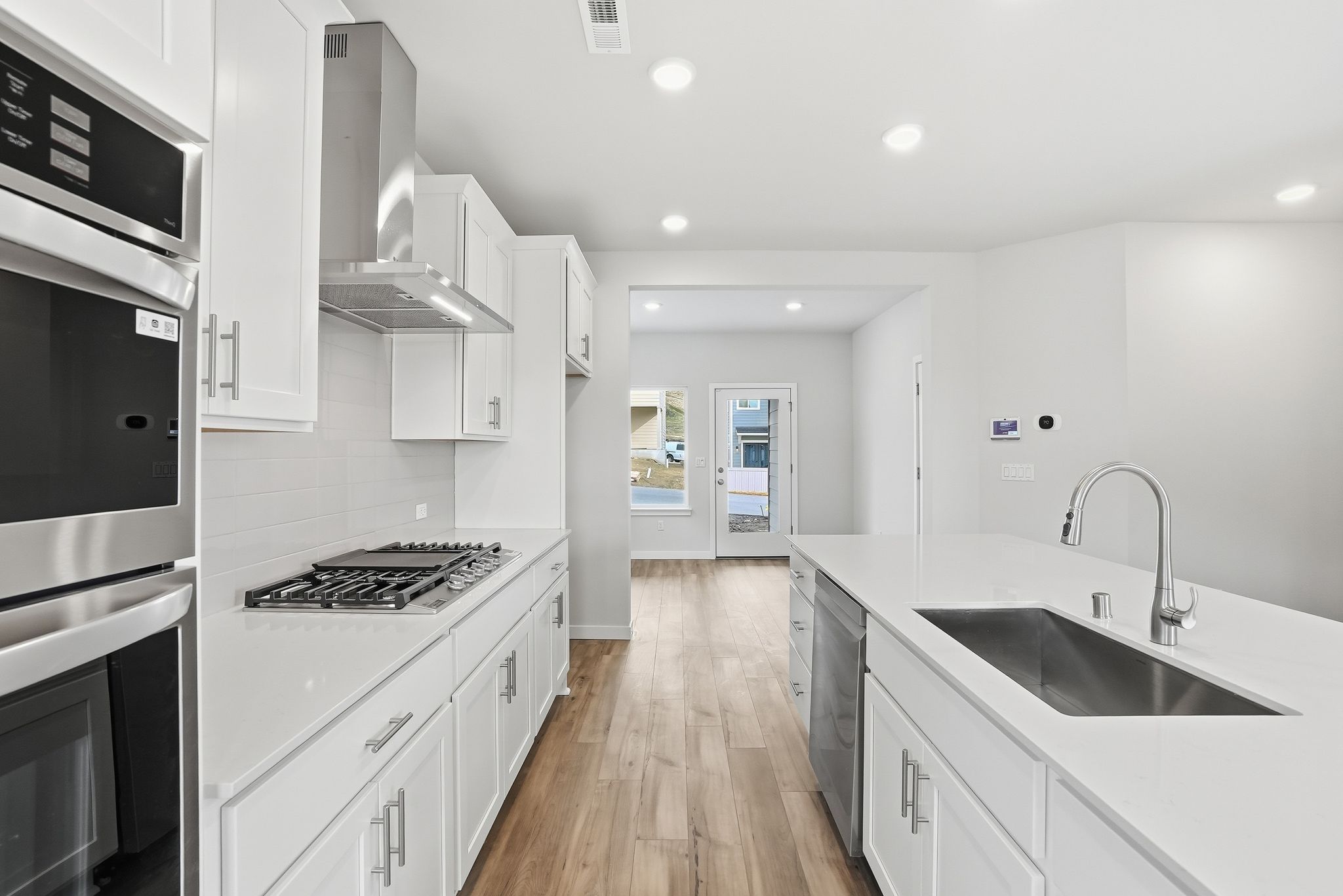 A kitchen with white cabinets.