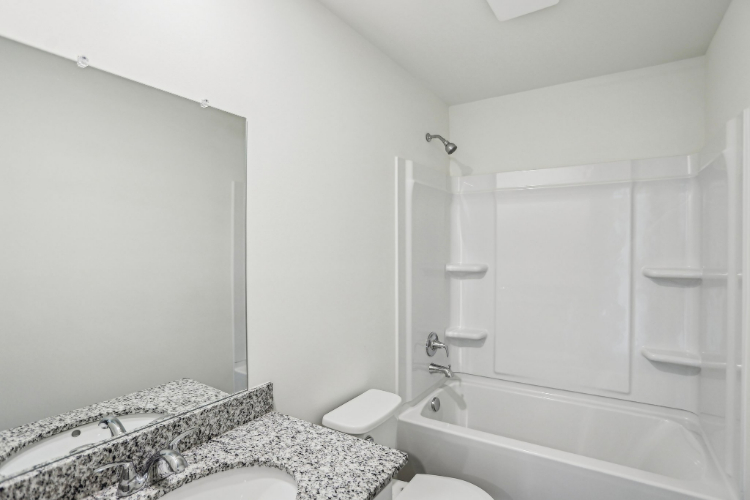A bathroom with a bathtub sink and toilet.
