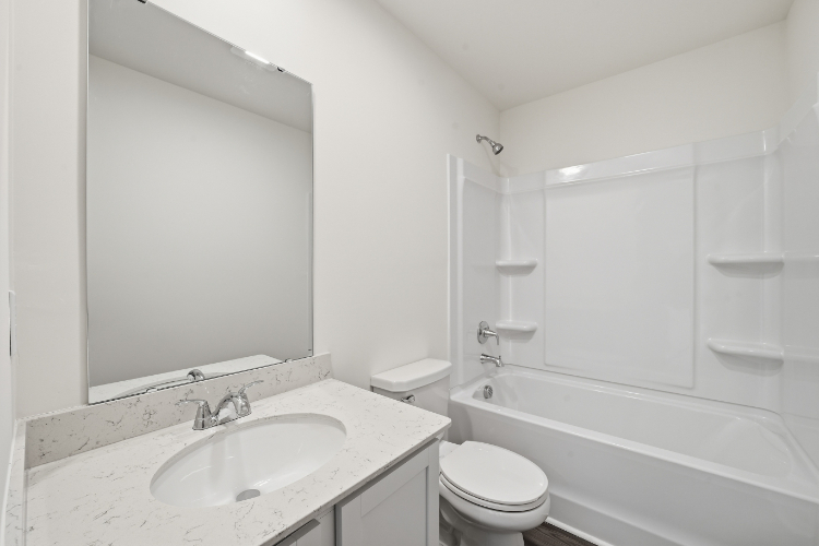 A bathroom with a sink toilet and bathtub.