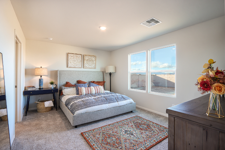 A bedroom with a large window.