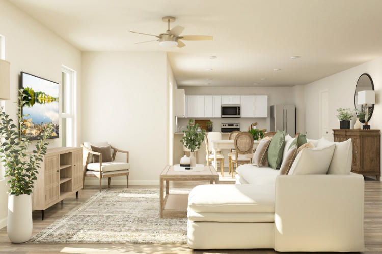 A living room with a white couch and a white table.