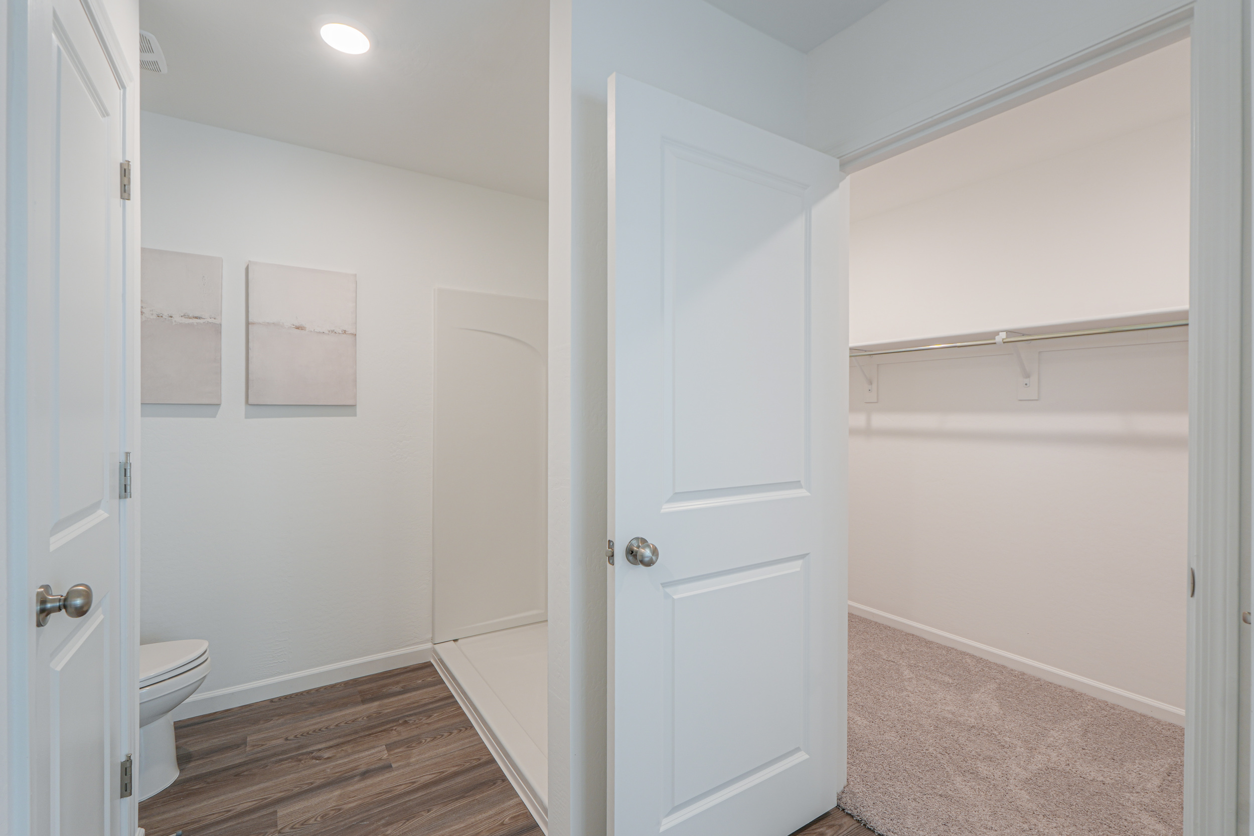 A bathroom with white doors.