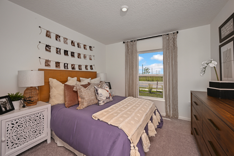 A bedroom with a large window.