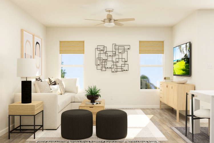 A living room with a white couch and a black chair.