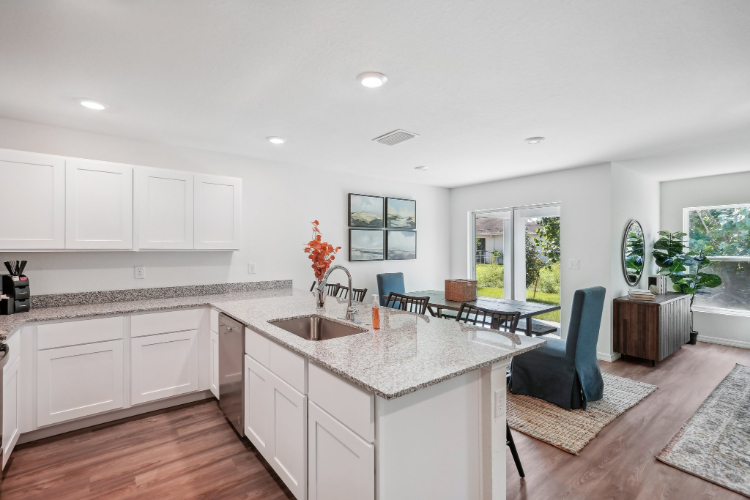 A kitchen with white cabinets.