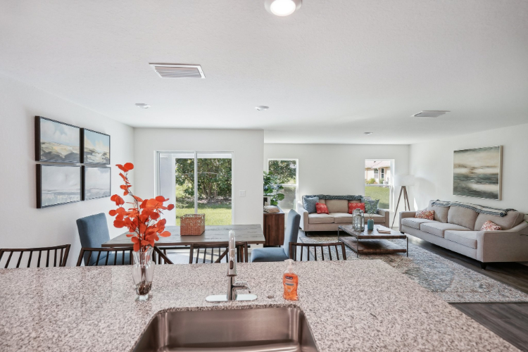 A living room with a large table and chairs.