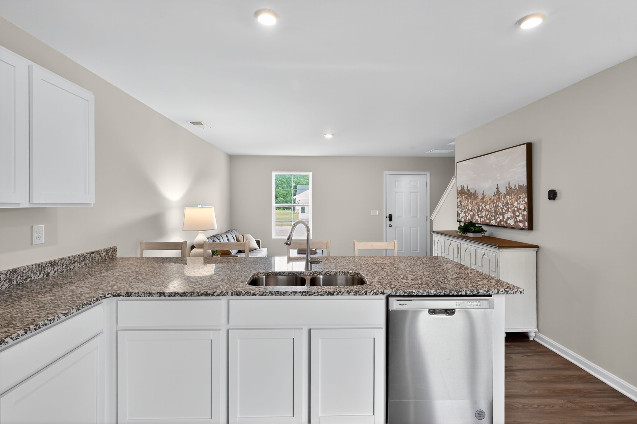 A kitchen with marble counters.