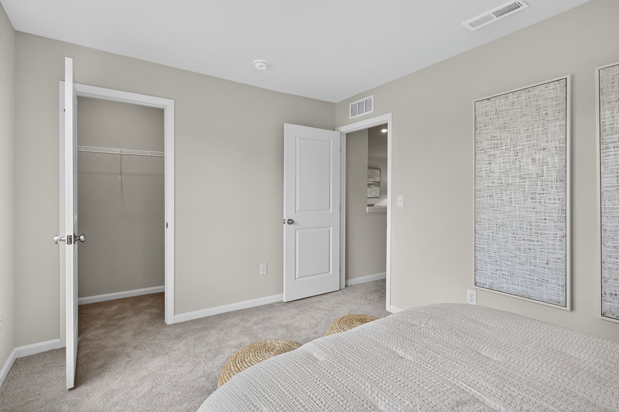 A bedroom with a bed and a shower.