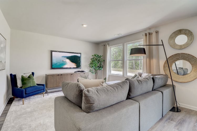 A living room with a couch and a tv.