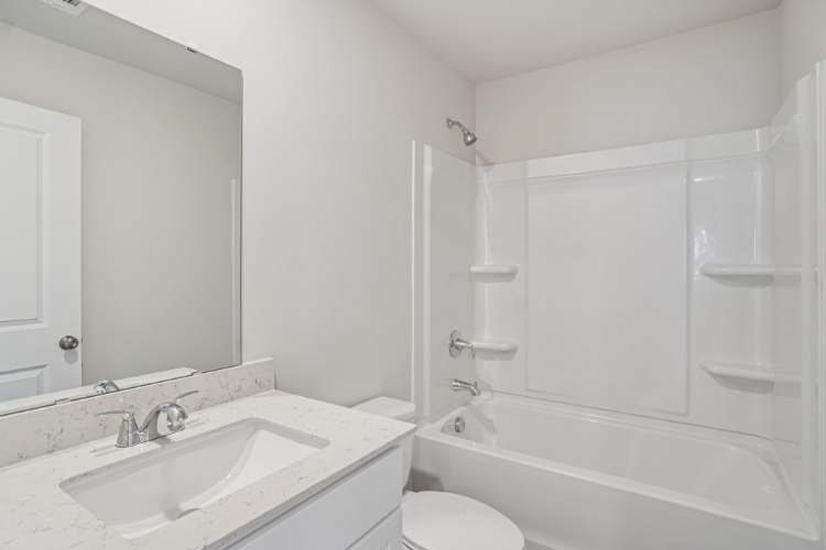 A bathroom with a sink and a toilet.